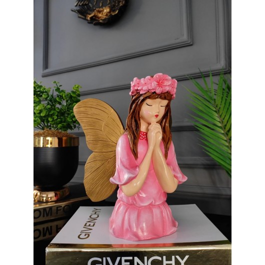 A Decorative Piece In The Shape Of A Girl With Wings