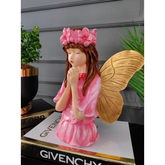 A Decorative Piece In The Shape Of A Girl With Wings