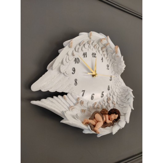 A Decorative Wall Clock In The Form Of Wings In White And Gold