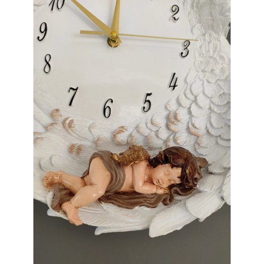 A Decorative Wall Clock In The Form Of Wings In White And Gold