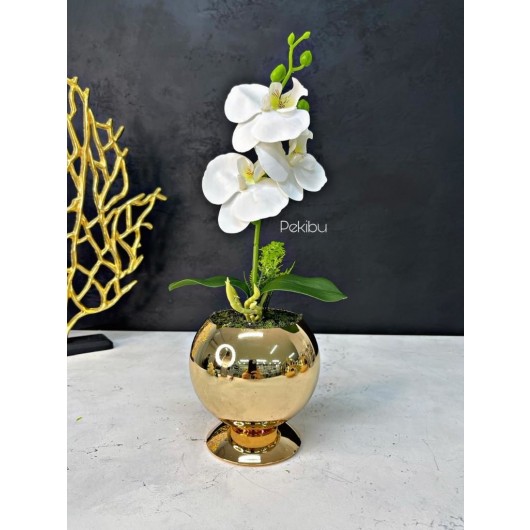 Decoration With A Small Orchid Arrangement In A Golden Ball Vase