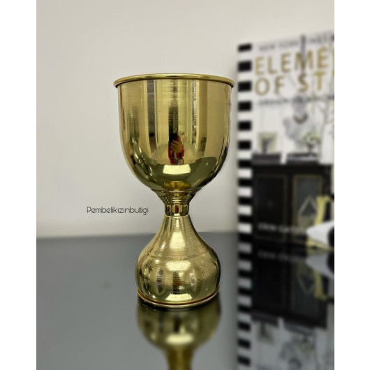 A Large Metal Vase With A Goblet-Shaped Design In Golden Color