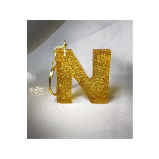ميدالية مفاتيح ايبوكسي برسم حرف N ذهبية لامعة