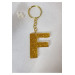 ميدالية مفاتيح ذهبية من الايبوكسي برسم حرف F