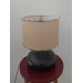 Black Desk Lamp With A Light Pink Head And A Silver Ribbon