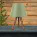 Wooden Lamp With Three Legs And A Green Cloth Head